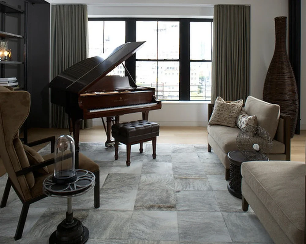Calcite ivory and grey cowhide rug in a living room with a piano